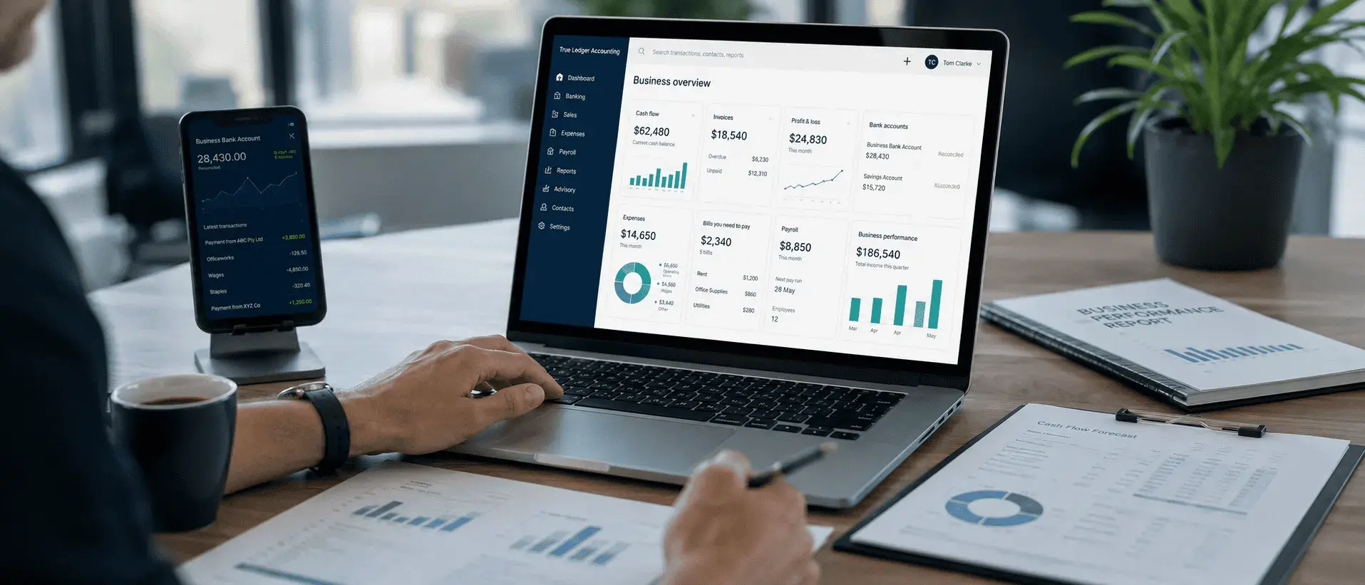 Laptop and phone displaying a Xero business overview dashboard with cash flow, invoices, profit and loss and bank account widgets