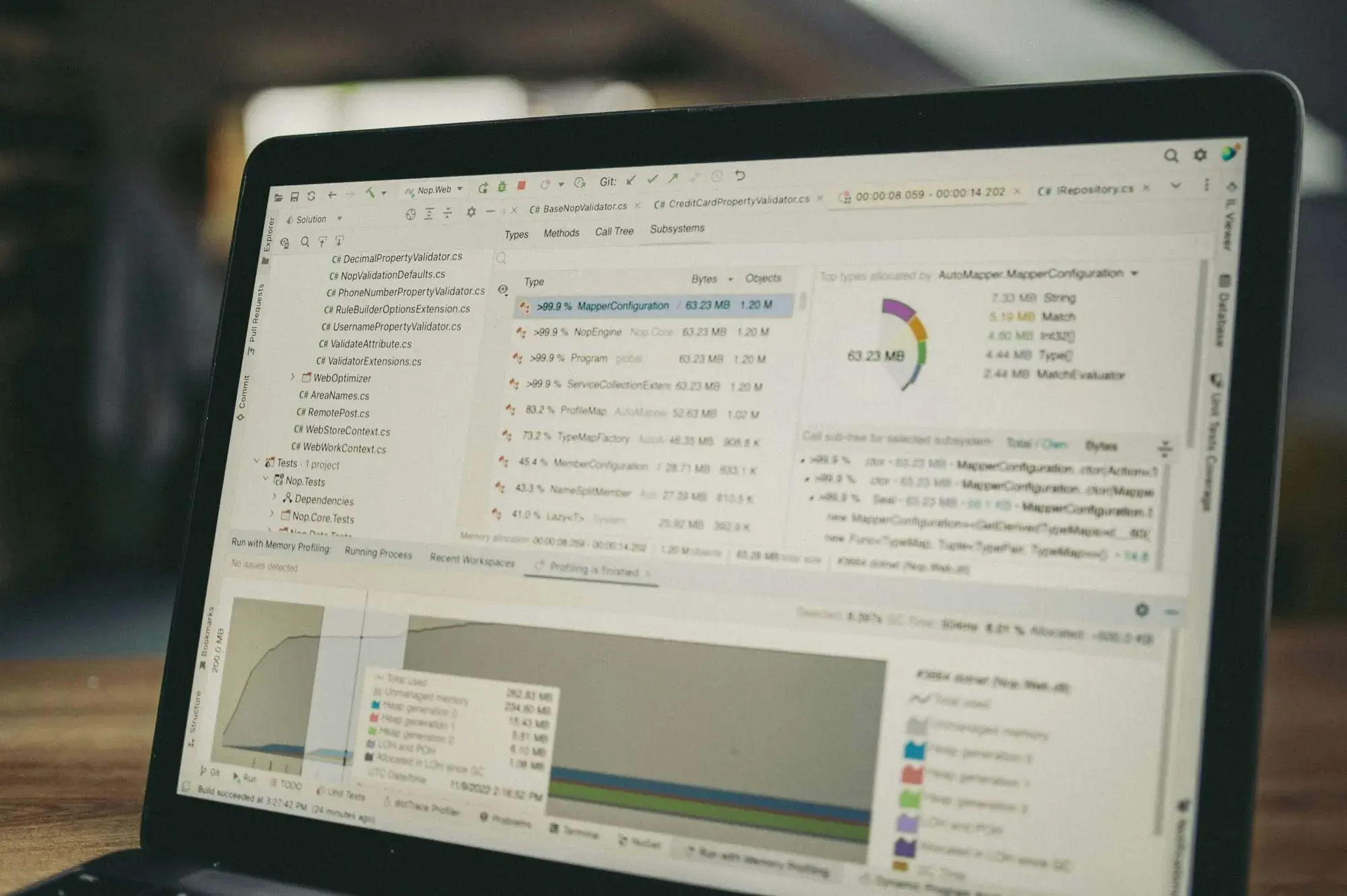 Laptop screen displaying software code and data analysis