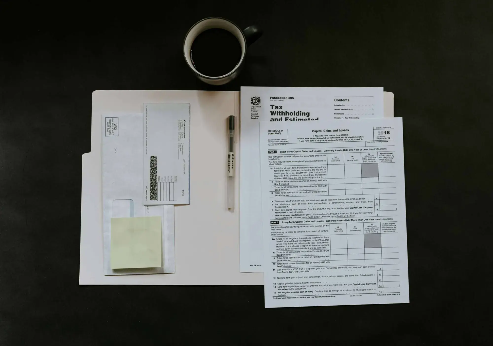 Financial documents, a calculator and pages of figures spread across a desk during a tax review